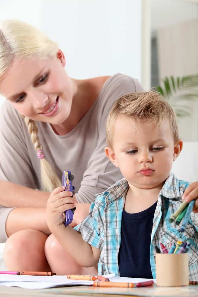 Toddler and mom drawing with crayons