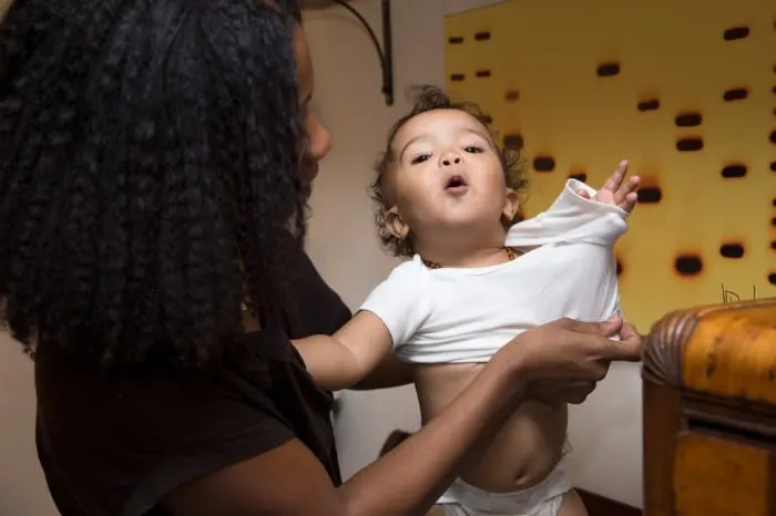 Mom getting toddler dressed