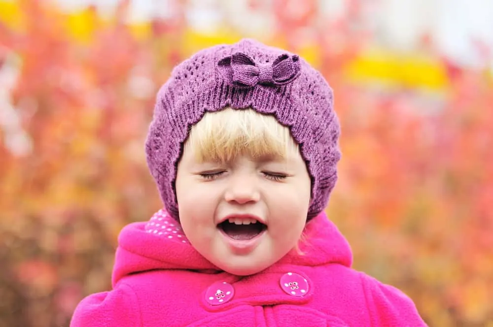 crying toddler girl on over the fall background