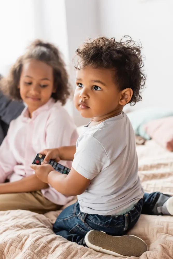 toddler holding remote control