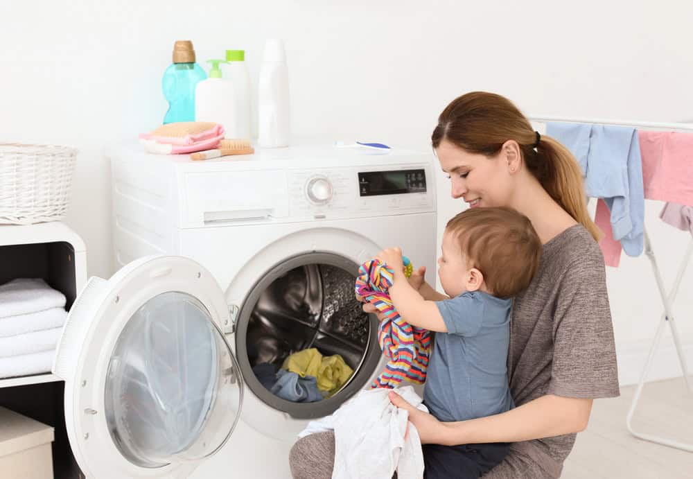 toddler helping with laundry